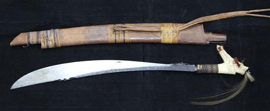 A Dayak stag horn-handled Mandau (head-hunters sword), wood scabbard, late 19th / early 20th century, total length 78.5cm (30.9in.)